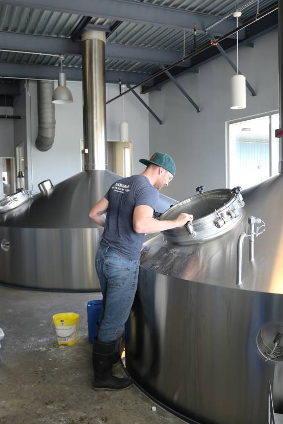 technician inspecting a metal container